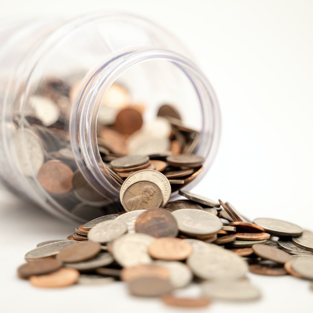 coins spilling out of tipped over jar to donate to Everyday is a Miracle