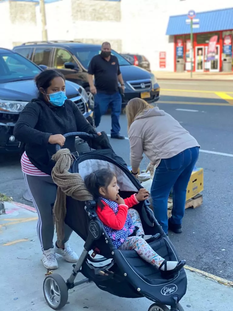 People waiting to be given food outside of Every Day is a Meracle Food Pantry in the Bronx
