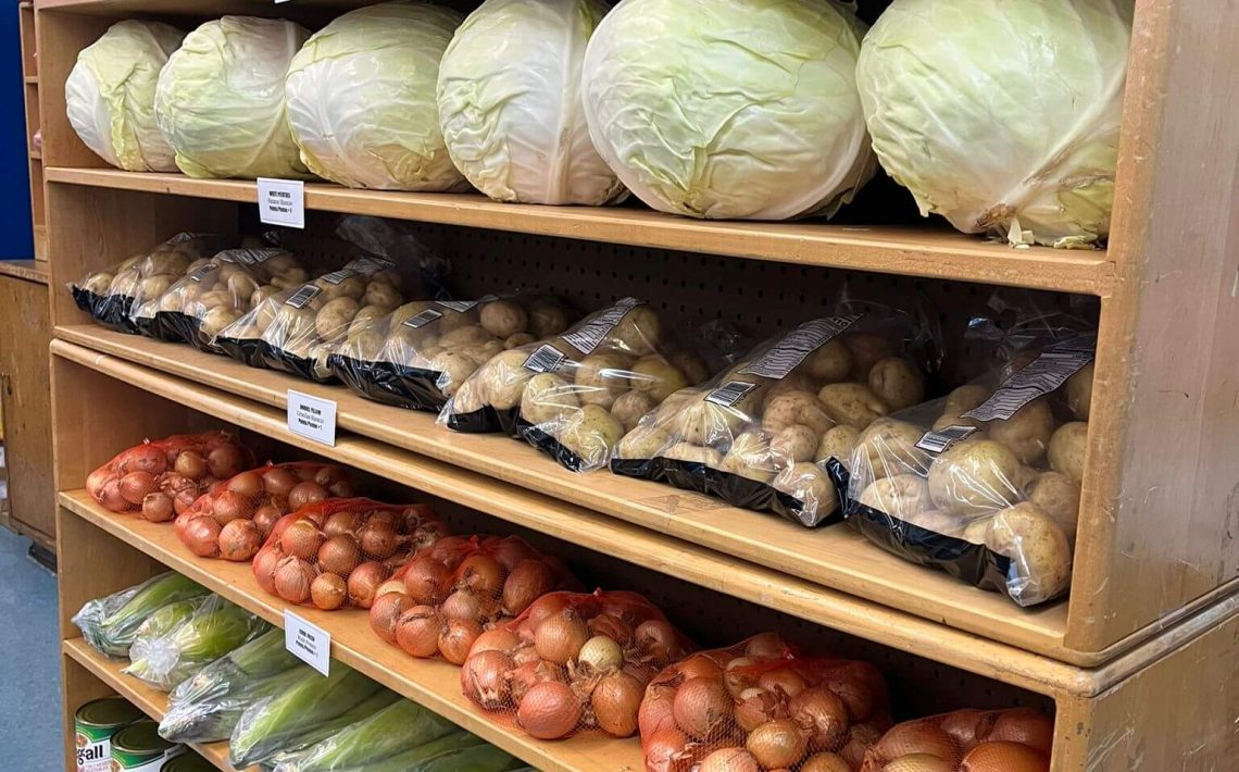 Vegetables stackes on shelves at the Every Day is a Miracle food pantry