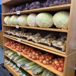Vegetables stackes on shelves at the Every Day is a Miracle food pantry