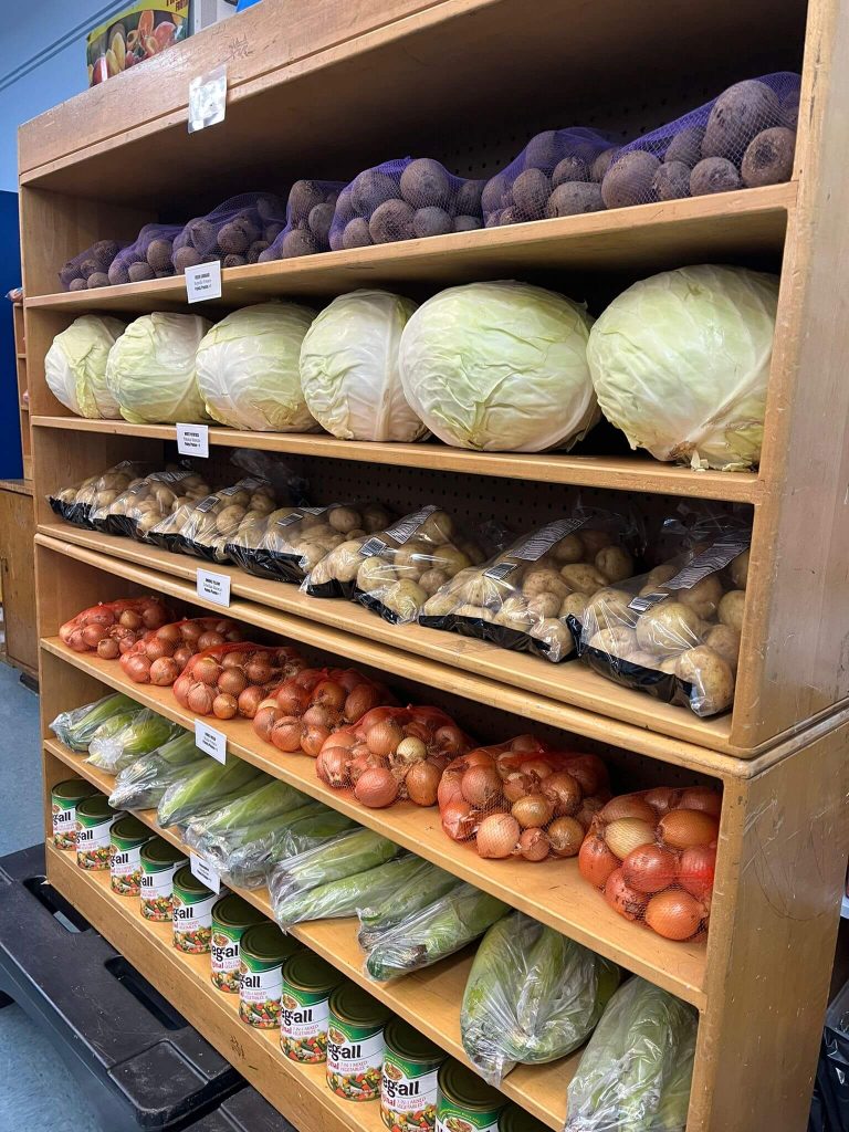 Vegetables stackes on shelves at the Every Day is a Miracle food pantry