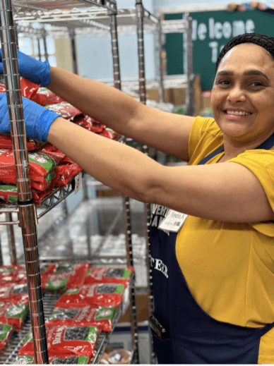 Woman stocking shelves at an EDMNYC food pantry